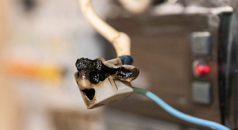 Burned wire, splicing connector, electrical terminal block of nonflammable, fireproof material. Faulty wiring or negligent electrical work. Dangerous short circuit accident. Southern Power Electric Fort Myers, FL damaged wiring repair