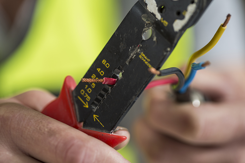 Electrician using wire stripper Southern Power Electric Fort Myers, FL trouble shooting electrical issues