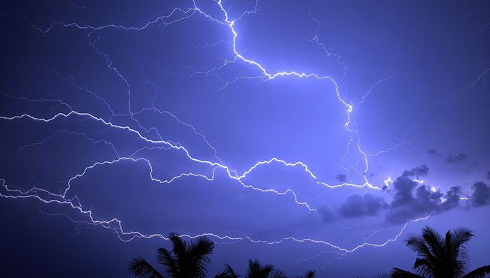 Lightning thunderstorm flash over the night sky storm strikes on house