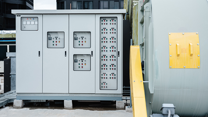 The electrical room of a commercial building contains multiple smart meters, a main power breaker, and various meter stacks and cabinets. The electrical room of a commercial building contains multiple smart meters, a main power breaker, and various meter stacks and cabinets.